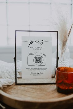 a table with a sign and glass on it