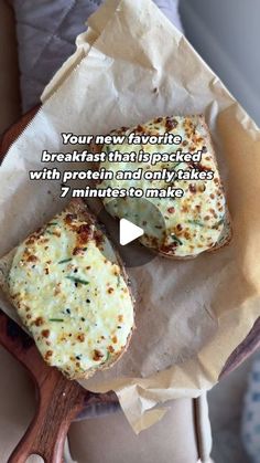 two pieces of bread sitting on top of a wooden spoon