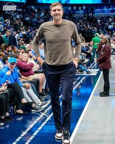 a man is walking down the runway at a sporting event