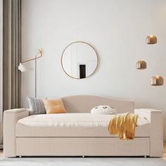 a living room filled with furniture and a round mirror hanging on the wall above it