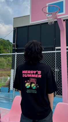 a person standing in front of a pink basketball hoop