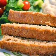 slices of meatloaf sitting on top of a white plate