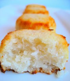 two pieces of cake sitting on top of a white plate next to another piece of bread