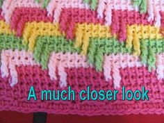 a close up of a crocheted dishcloth with words underneath it that read, a much closer look