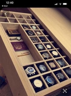 an open drawer with many different watches in it