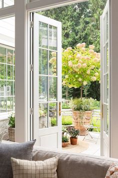 a living room filled with furniture and flowers