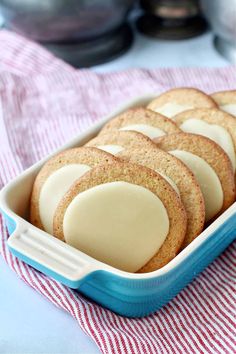 a blue dish filled with cookies on top of a red and white checkered table cloth