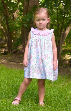 Meet Isla- Your little one's go-to floral dress for the warmer months. She's comfy, soft, and features the most gorgeous pink ruffled collar with smocking details. 100% Cotton, lined, with button back closure. * Matching Bubble Available. Cute Smocked Dress For Spring Garden Party, Cute Floral Print Smocked Dress For Garden Party, Spring Dress With Smocked Bodice For Playdate, Spring Pink Smocked Dress With Flutter Sleeve, Cute Spring Dresses With Ruffled Collar, Cute Spring Dress With Ruffled Collar, Pink Dresses With Ruffled Collar For Spring, Spring Dress With Ruffles And Peter Pan Collar, Spring Dress With Peter Pan Collar And Ruffles