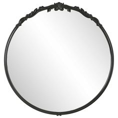 a round mirror with an ornate design on the bottom and black trimming around it