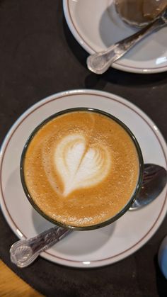 a cup of cappuccino with a heart drawn on it