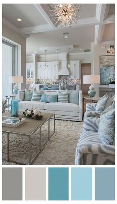 a living room filled with lots of furniture and blue accents in shades of gray, white, and light blue