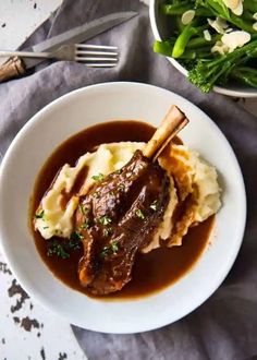 a white bowl filled with meat and mashed potatoes