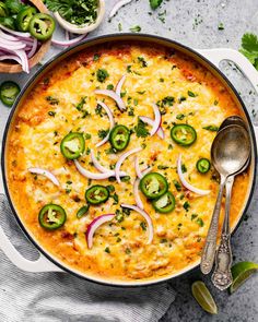 an overhead view of a casserole dish with onions, peppers and jalapenos