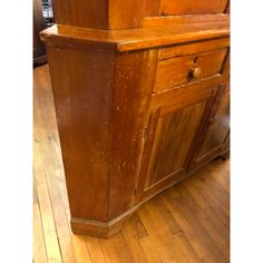 an old wooden cabinet is sitting on the floor