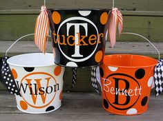 three buckets decorated with polka dots and the word't'is shown in black, orange, and white