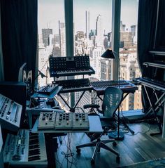 recording equipment in front of large window overlooking city