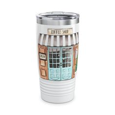 a white coffee cup with a store front on it