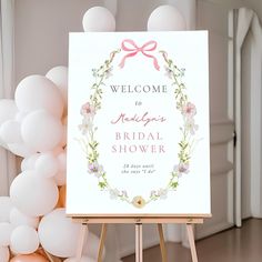 a welcome sign for a bridal shower on an easer with balloons in the background