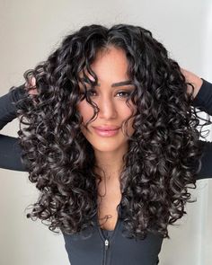 Dive into the trend of layered curly haircuts 2024 that brings out the beauty of natural curls. Ideal for those seeking a fresh look, this style is perfect for medium to long hair lengths. Embrace your natural curls 3b with soft layers that add volume and movement. Whether you have a round face or seek a flattering shape, these haircuts offer a stunning transformation. Oval Haircut Curly Hair, Curly Hair Medium Length Layers, One Length Haircuts Curly, Very Layered Curly Hair, Layers Medium Curly Hair, Long Hair Curly Haircuts, Long Curly Layers With Bangs, Long Layers Medium Length Hair Curly, Long Curly Layered Hair With Bangs