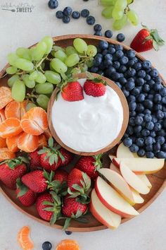 fruit platter with yogurt, grapes, strawberries, oranges and blueberries