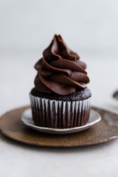 a chocolate cupcake sitting on top of a plate