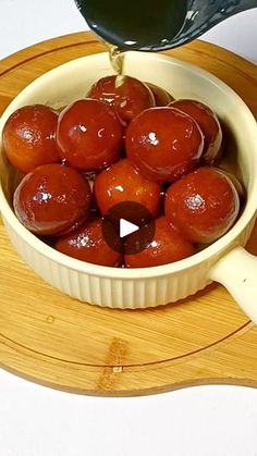 a bowl filled with lots of food sitting on top of a wooden cutting board next to a spatula