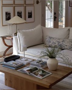 a living room filled with furniture and pictures on the wall