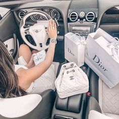 a woman sitting in the driver's seat of a car