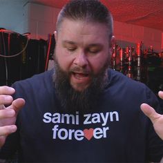 a man with a long beard wearing a t - shirt that says sani zayn forever