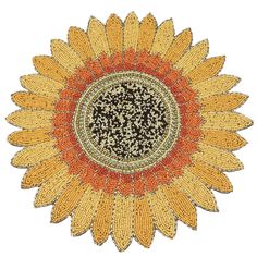 an orange and yellow sunflower with black spots on the center is featured in this image