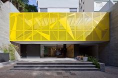 a yellow building with stairs leading up to it