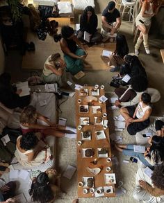 a group of people sitting around a wooden table