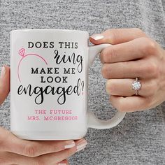 a woman holding a coffee mug with the words does this ring make me look engaged?