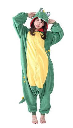 a woman in a green and yellow animal onesuit is standing with her hands on her head