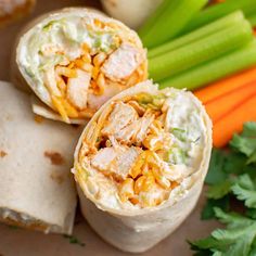 two burritos filled with chicken, cheese and veggies