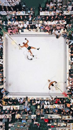 an overhead view of two men wrestling in a ring