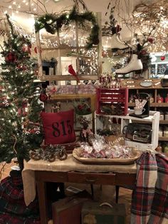 a table with christmas decorations on it in a room filled with other furniture and decor