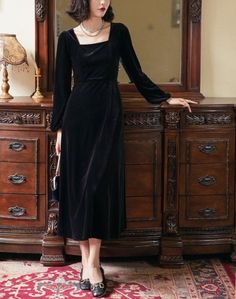 a woman standing in front of a dresser