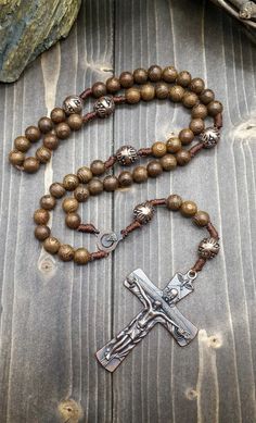 Wood Rosary Beads Necklace Catholic wooden rosary necklace with Our Father Cross and Madonna medal. Cross (H X W) : 7 cm x 3.5 cm / 2.8" x 1.4" Rosary Length: 49 cm / 19", Nazareth Store Customized Gift Velvet Bag Religious rosary of Nazareth Store makes a wonderful gift for any occasion, birthday, confirmation, First Communion, Baptism, Mother day, Christening & ideal gift for Catholic and Orthodox Christians. packed in a velvet bag to provide extra protection. Vintage Cross Necklaces With 8mm Beads, Vintage Cross Necklace With 8mm Beads, Bronze Jewelry With Wooden Beads For Gift, Vintage Cross Jewelry With 8mm Beads, Antique Jewelry With 8mm Beads As Gift, Antique Jewelry With 8mm Beads For Gift, Antique 8mm Beads Jewelry As Gift, Brown Crucifix Necklace In Spiritual Style, Spiritual Brown Crucifix Necklace