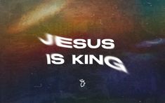 the words jesus is king are painted on a dark background with white letters and an abstract design