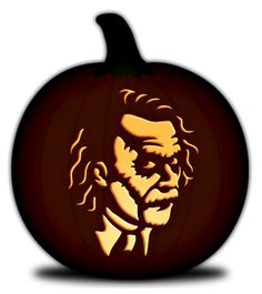 a carved pumpkin with an image of abraham lincoln on it's face in the dark