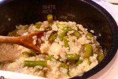 rice and vegetables are being cooked in a pot