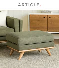 a green chair and footstool sitting in front of a white wall with the words article on it