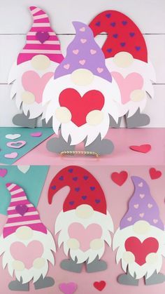 some paper gnomes with hearts on them and one is cut out to look like they are