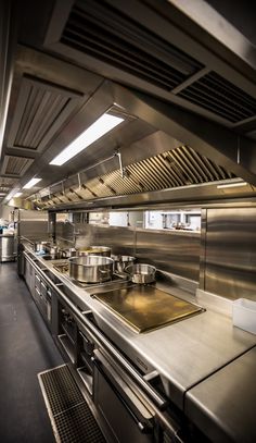 an industrial kitchen with stainless steel appliances and counters