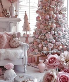 a pink christmas tree in a living room with white furniture and flowers on the floor