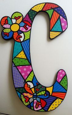 the letter c is made up of brightly colored tiles and has mickey mouse on it