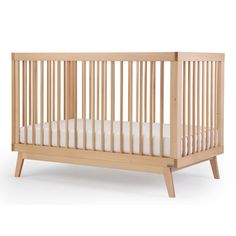 a small wooden crib with white sheets on the bottom and sides, against a white background