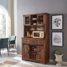 a dining room with a table, chairs and a wine rack on the side of it