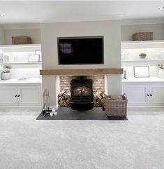 a living room filled with furniture and a flat screen tv mounted above a fire place